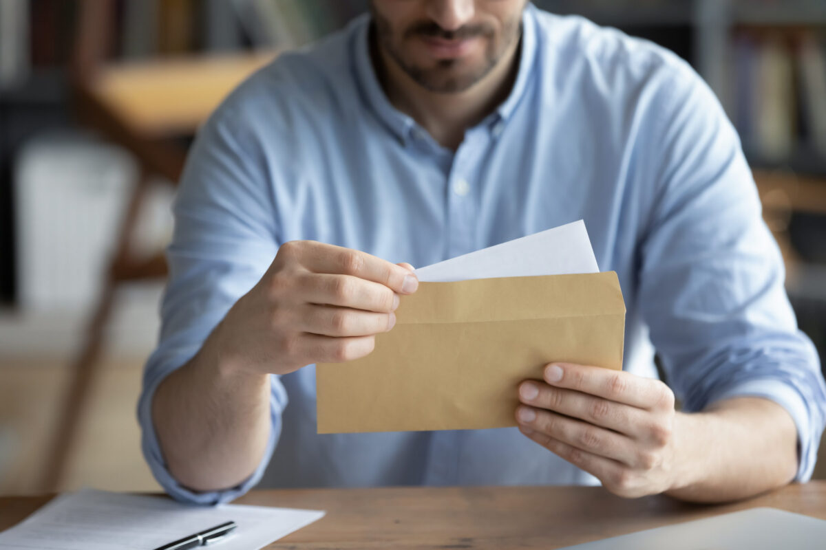 Employee reviewing final paycheck documents after being fired in California