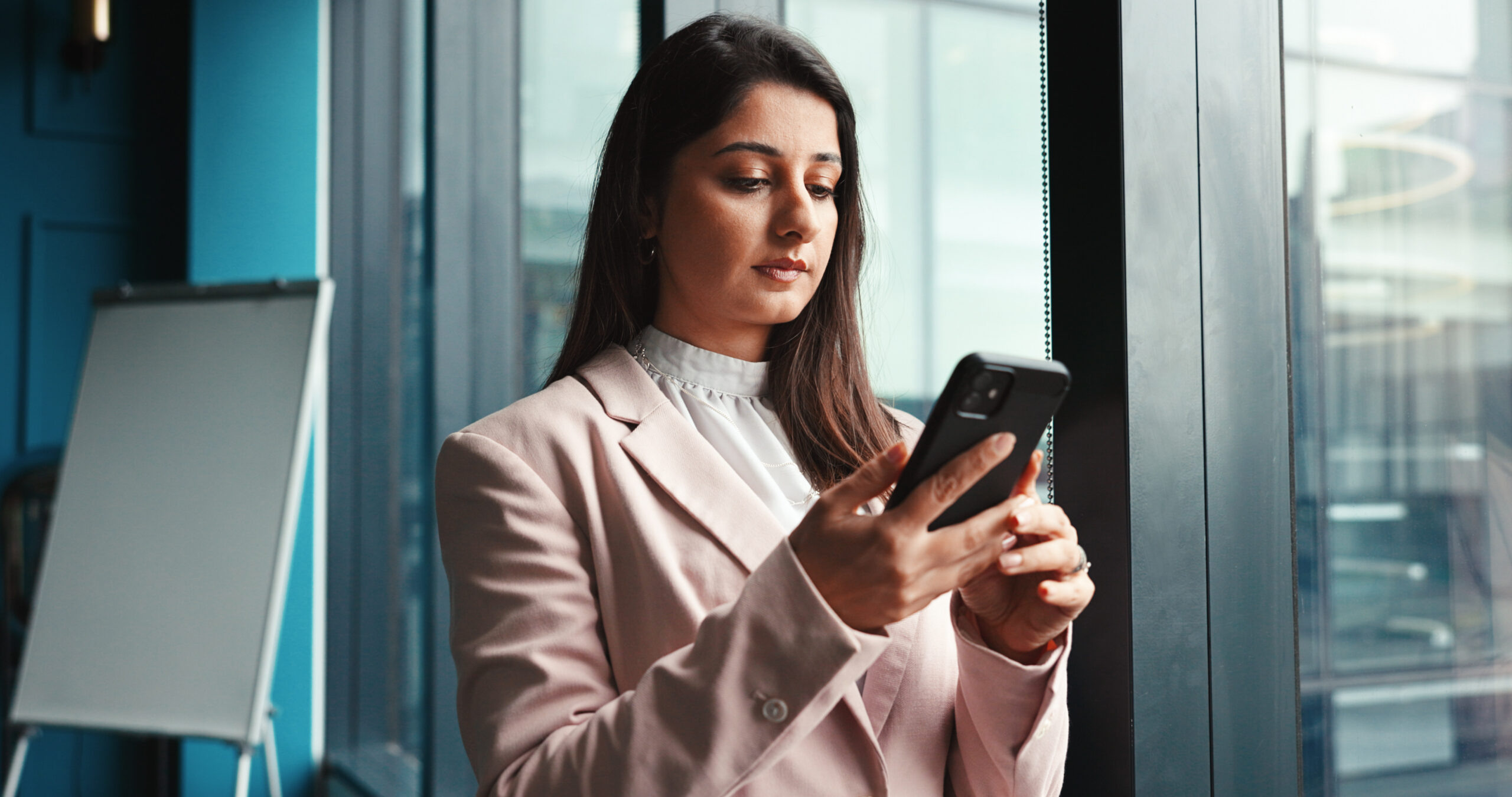 California employee reviewing messages on phone to document workplace sexual harassment