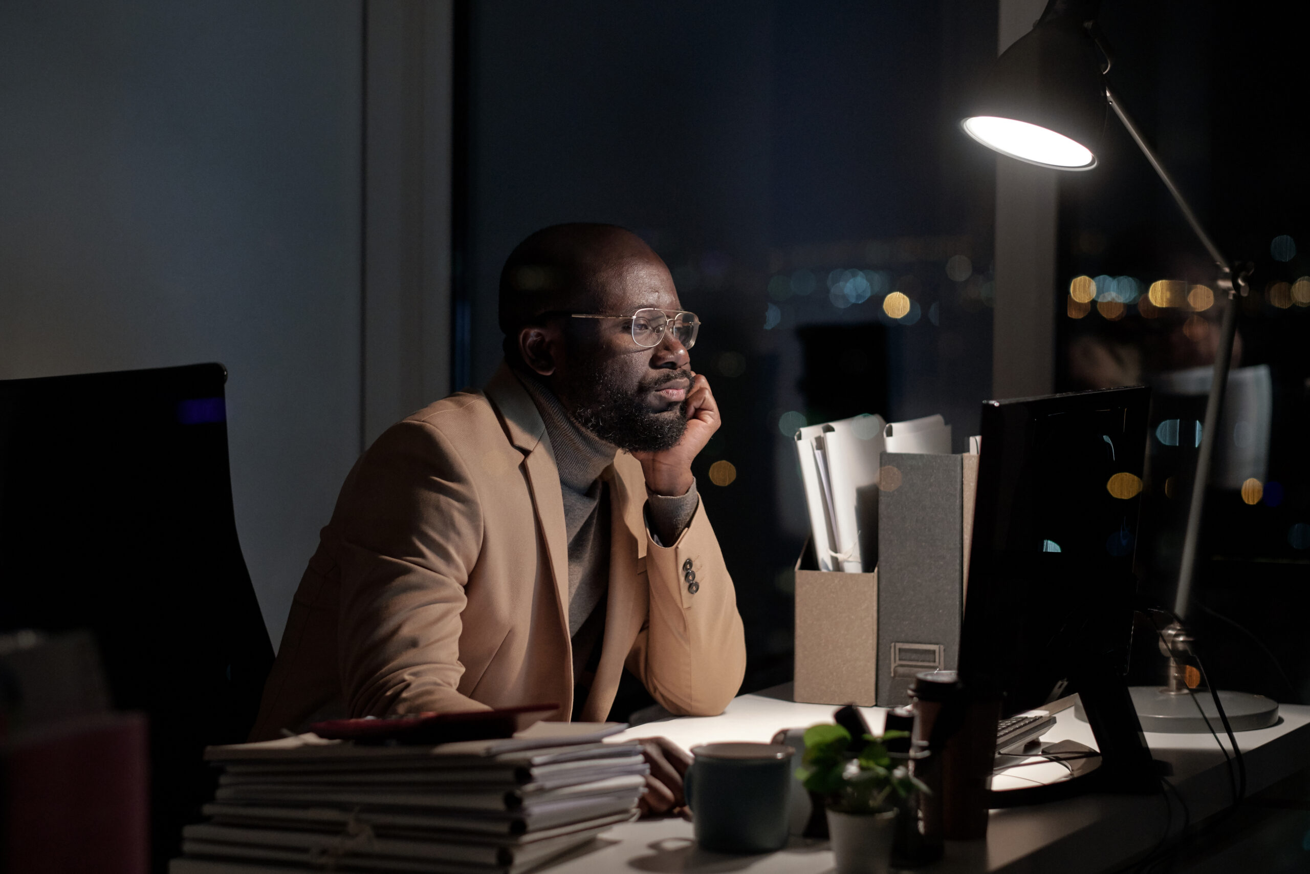 Employee working late at night in an empty office, a common California overtime pay violation when hours go uncompensated