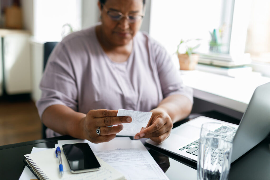Employee carefully reviewing a pay stub to check for overtime errors