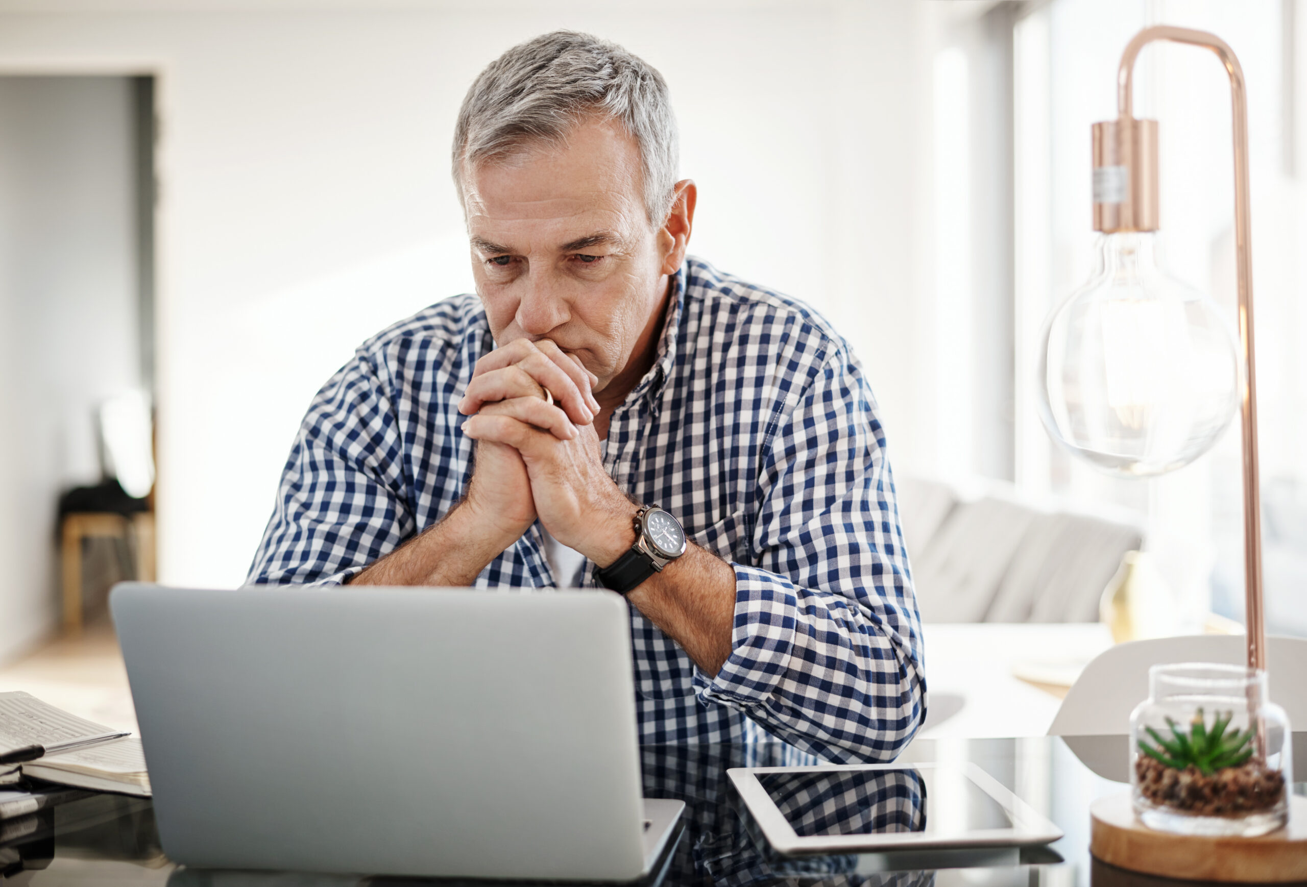 Man researching wrongful termination lawyer options at home after losing his job in California