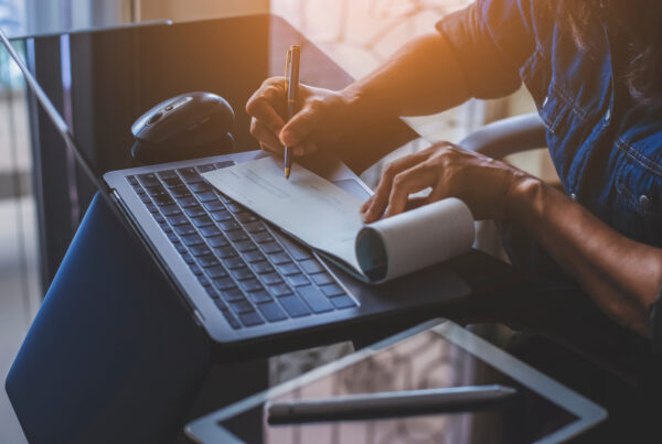 Employee reviewing pay documents and overtime wage records at a desk under California overtime law