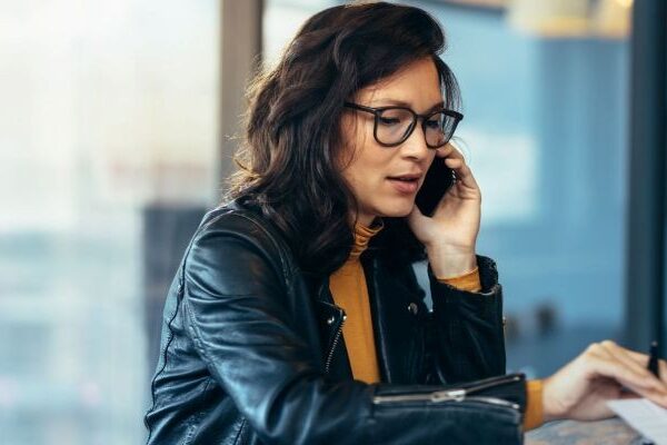 A California employee on the phone with the EDD reviewing documents to collect unemployment benefits after being fired