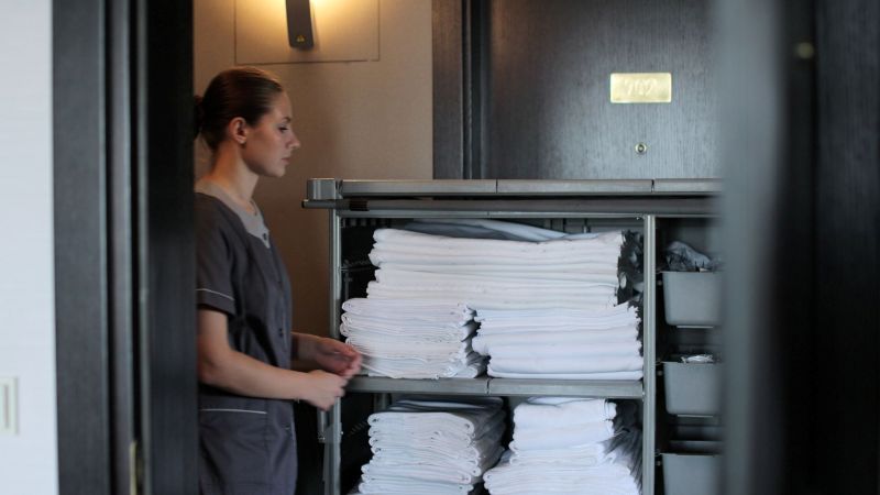 Hotel housekeeper preparing for an evening shift in California — split shift pay rules apply to hospitality employees