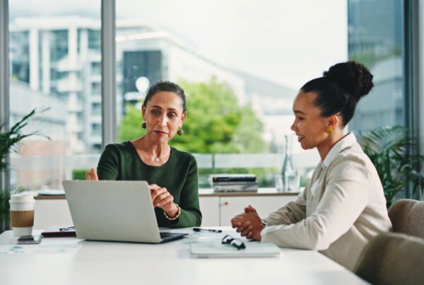 California employee discussing a performance improvement plan with an HR representative in a modern office