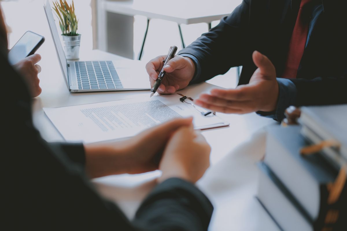 Employment attorney reviewing California minimum wage violation documents with employee during free consultation