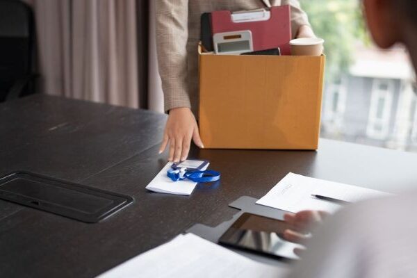 Employee carrying belongings box after involuntary termination in California