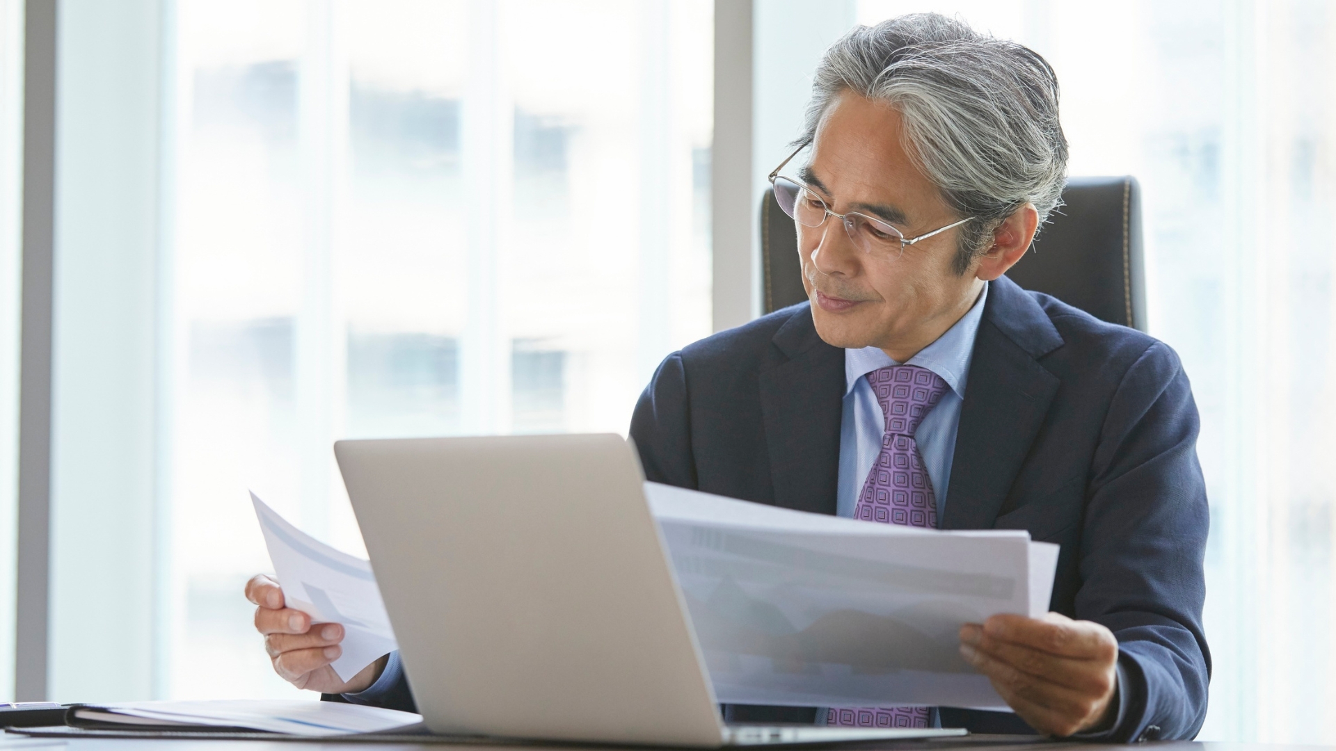 Attorney reviewing wrongful termination claim documents at a desk in California