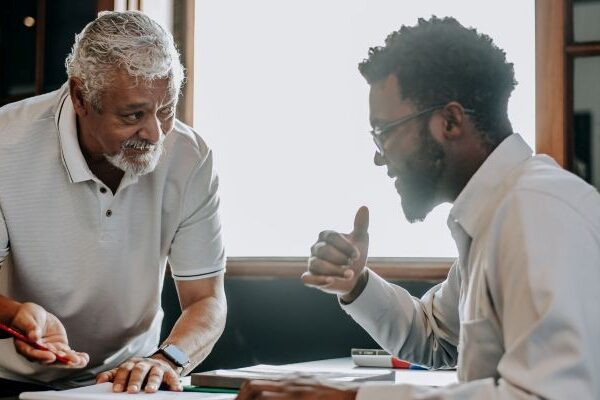 Two colleagues in a workplace discussion — signs of age discrimination dynamics at work in California