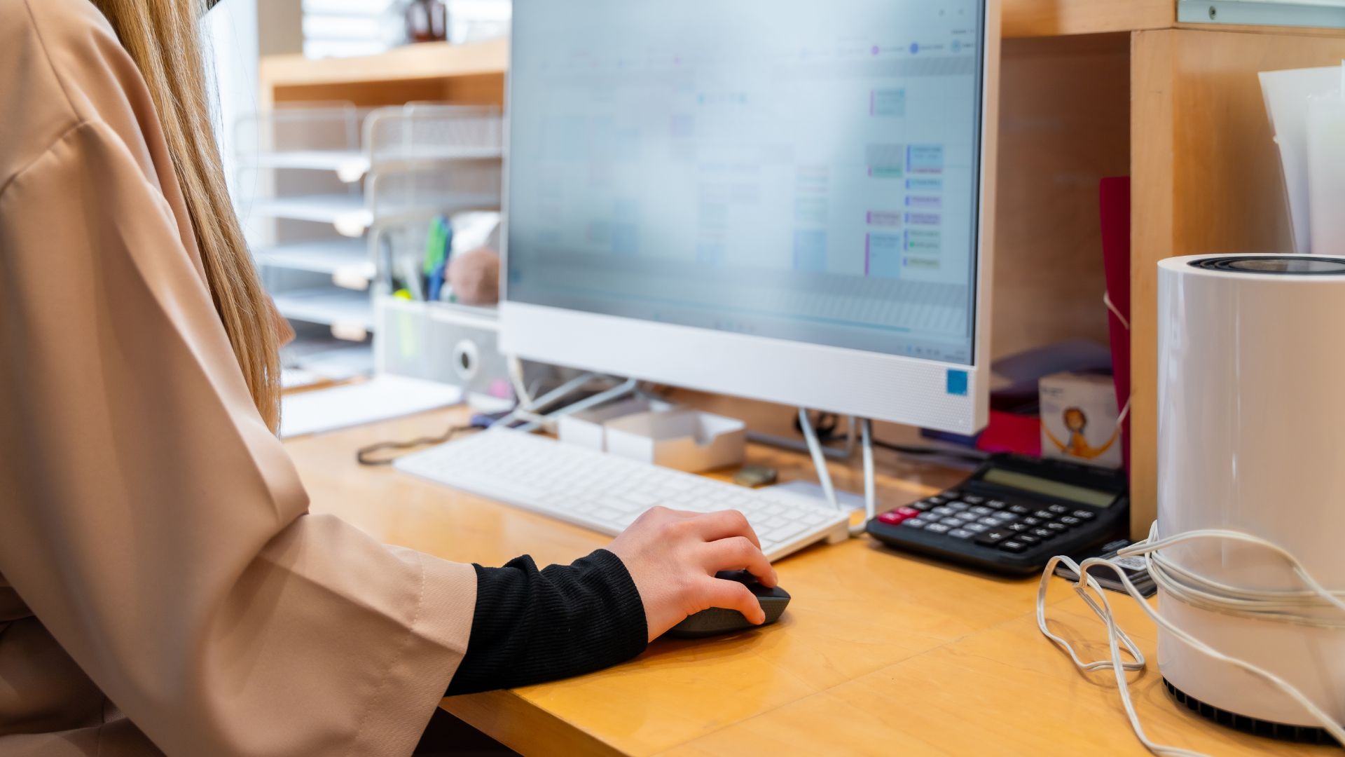 Employee at a desktop computer researching wrongful termination rights in California