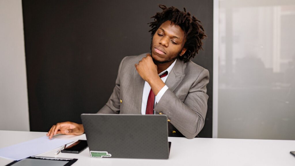 Employee sitting at desk reviewing documents after a difficult workplace situation