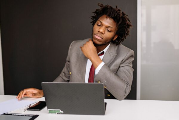 Employee sitting at desk reviewing documents after a difficult workplace situation