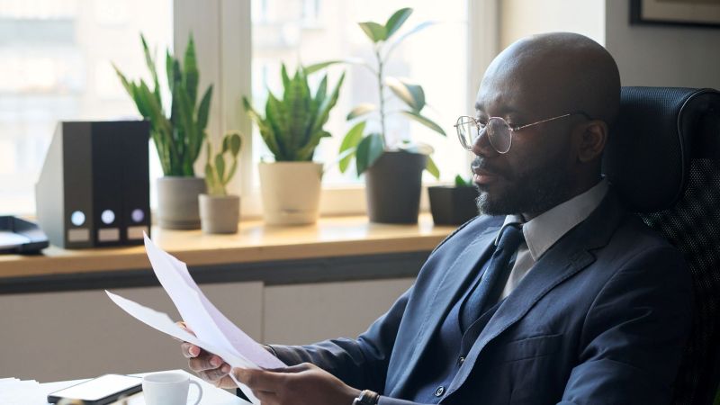 Employment attorney reviewing case documents at an office desk in California