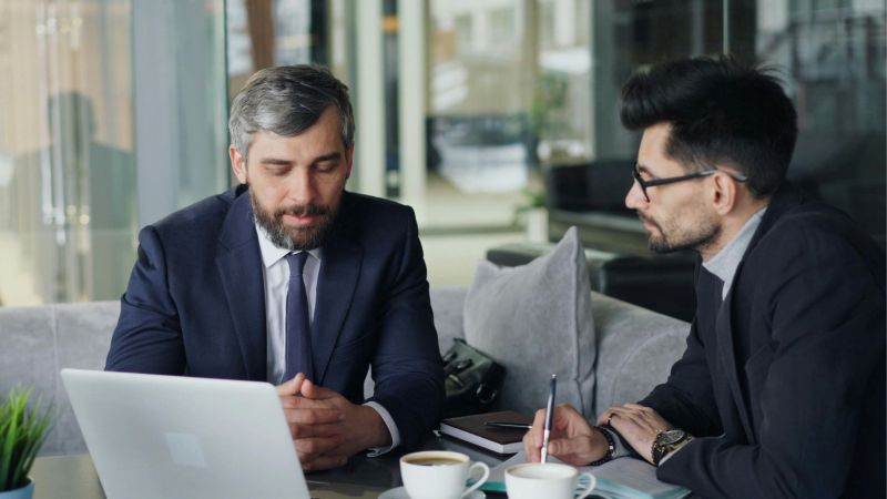 An employee meeting with a wrongfully fired lawyer in California to review his termination case