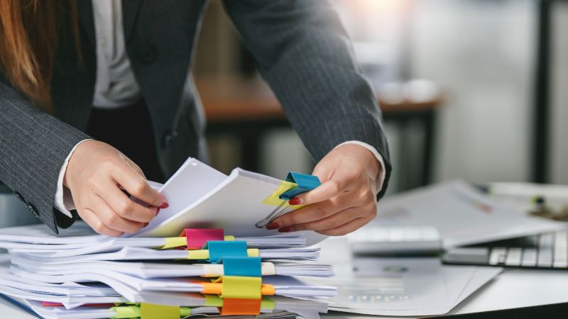Person gathering employment records as evidence in a California wrongful termination layoff claim