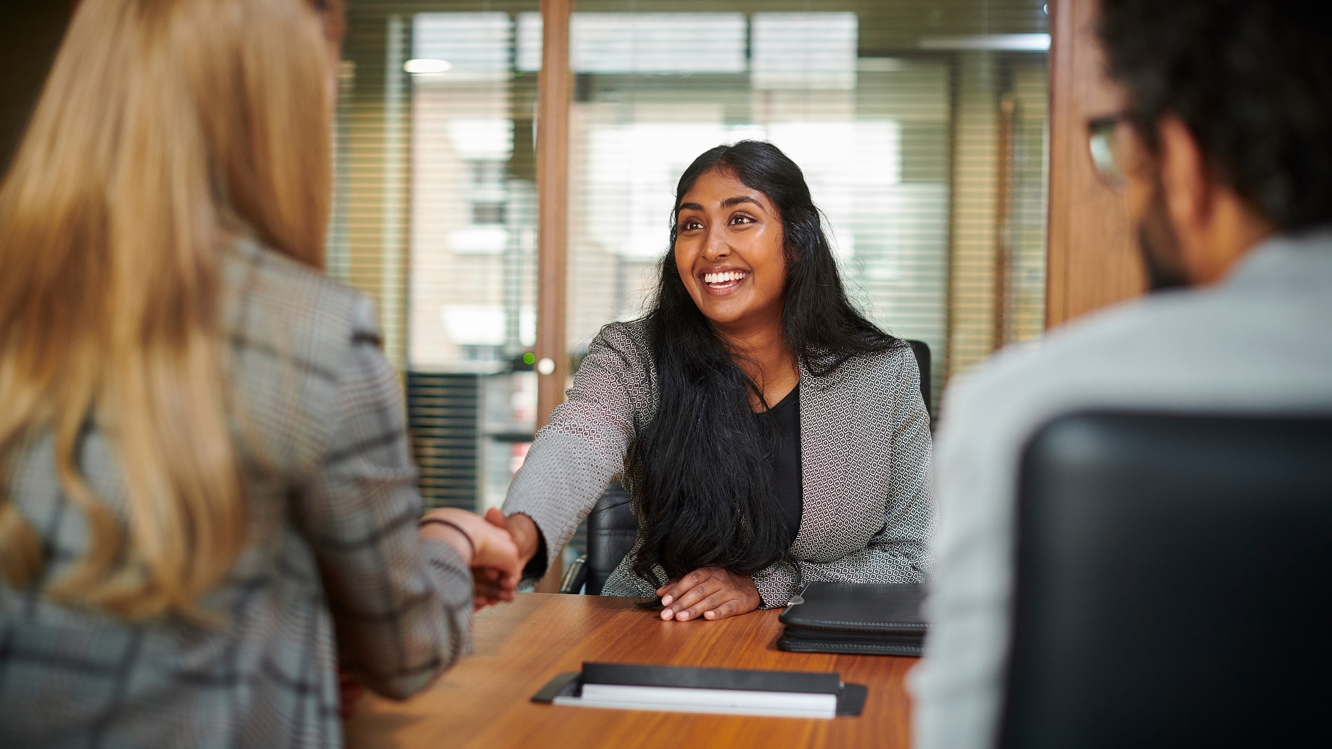 Sacramento employment lawyer shaking hands with a client during a free case consultation