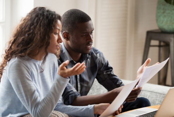Two employees reviewing documents to establish timing evidence in a workplace retaliation claim
