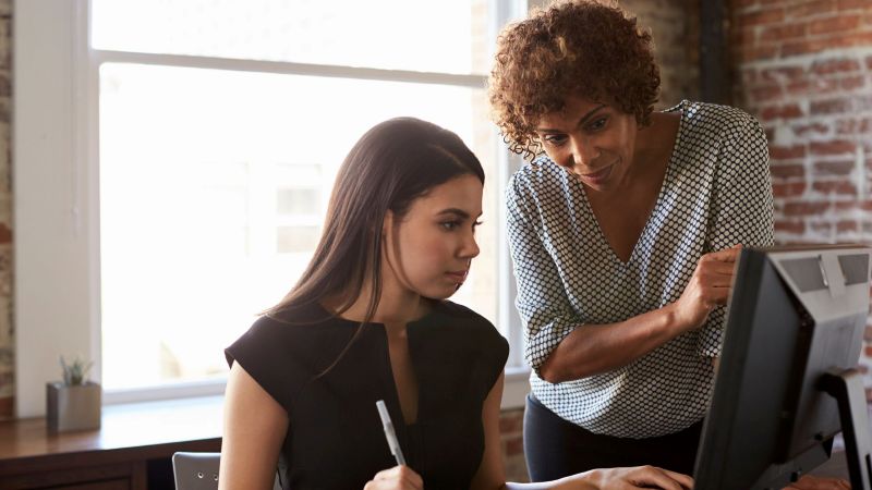 Employee reviewing documents with her attorney after being demoted for no reason in California