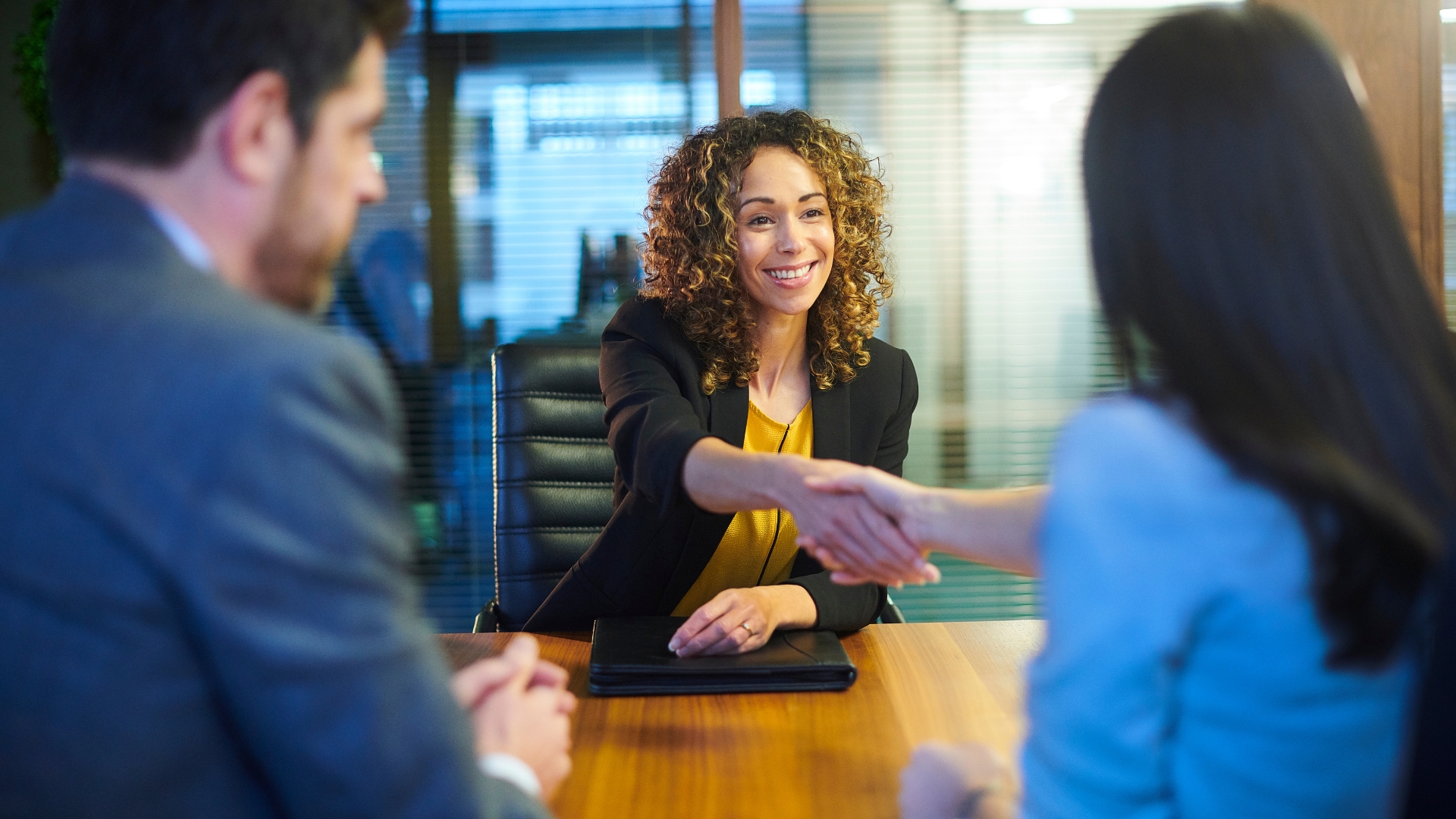 Attorney shaking hands with a client after agreeing to take on a wrongful termination claim