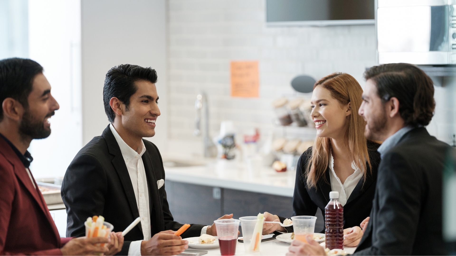 Diverse group of California employees talking during a work break — employees who work through meal periods or extended shifts without proper compensation may be owed double time pay