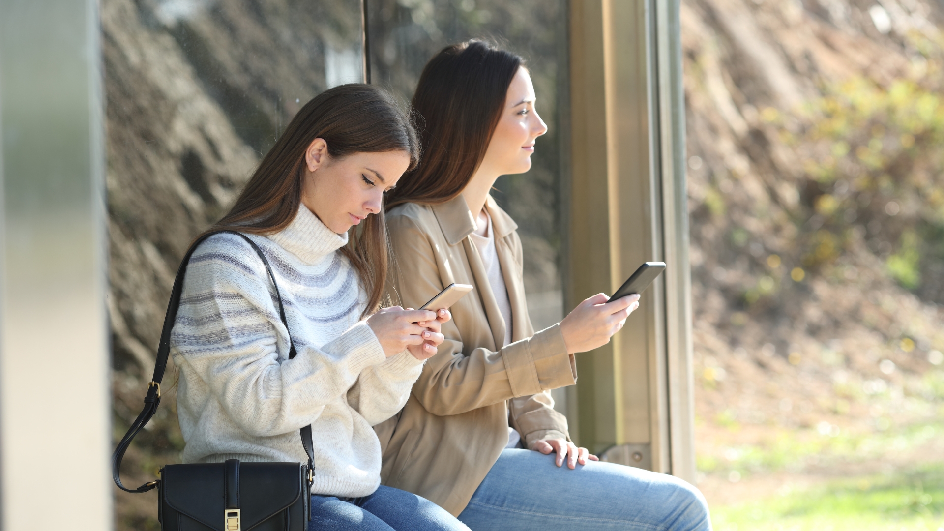 Los Angeles employees reviewing their workplace retaliation rights on their phones.