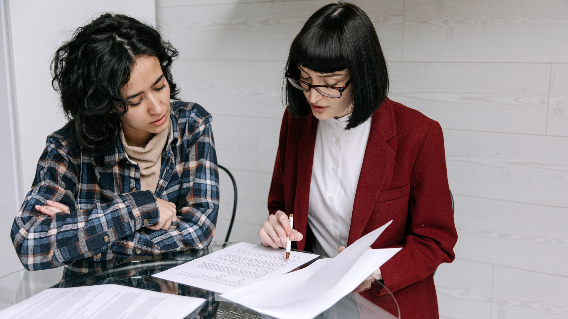 Employee reviewing hostile work environment lawsuit documentation with an attorney in California