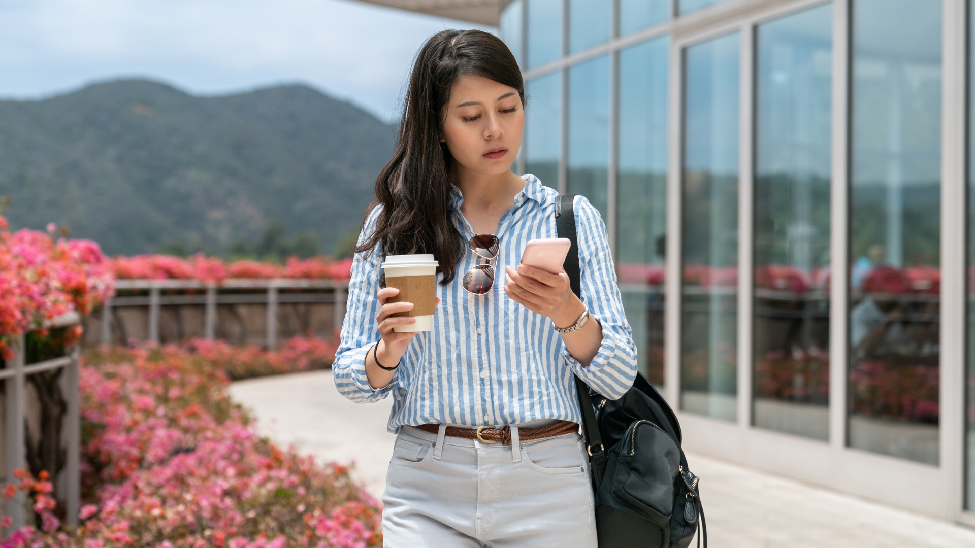 A Los Angeles employee checks her phone while considering calling a sexual harassment lawyer