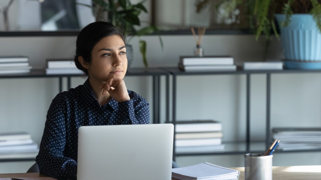 California employee at her desk considering how to prove a hostile work environment claim