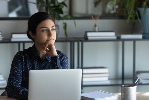 California employee at her desk considering how to prove a hostile work environment claim