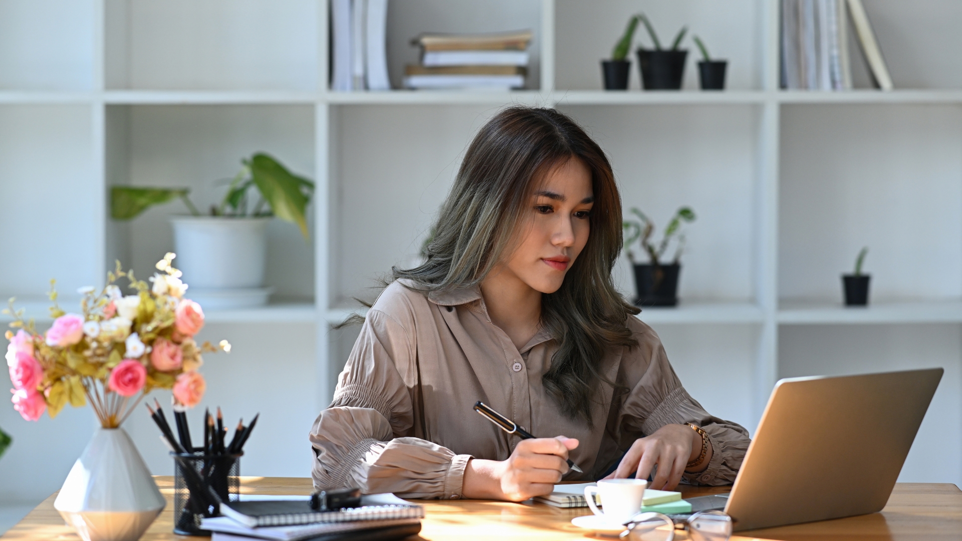 Professional woman documenting workplace harassment evidence with notes and a laptop