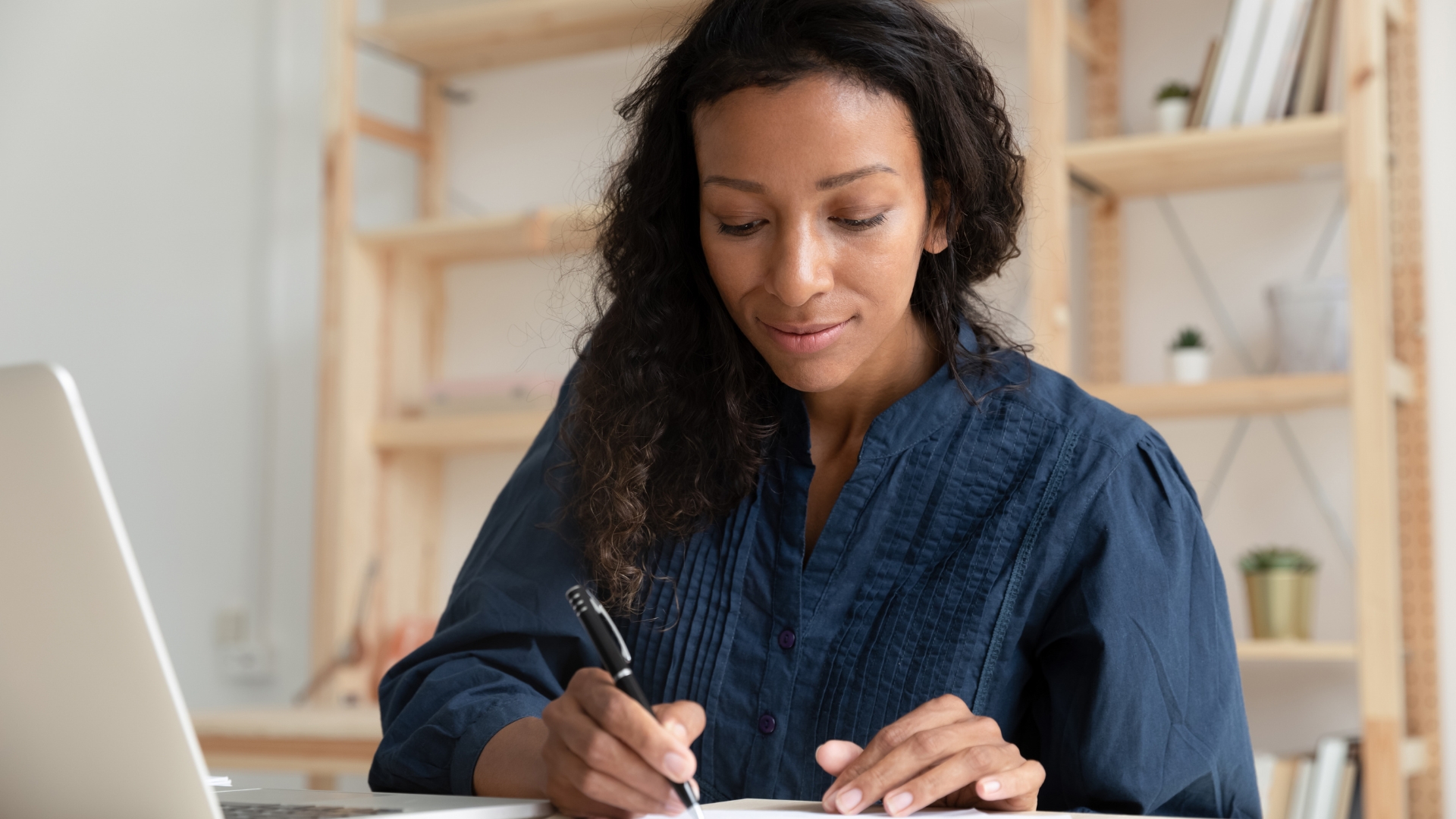 Employee writing notes to document gender discrimination at work in California