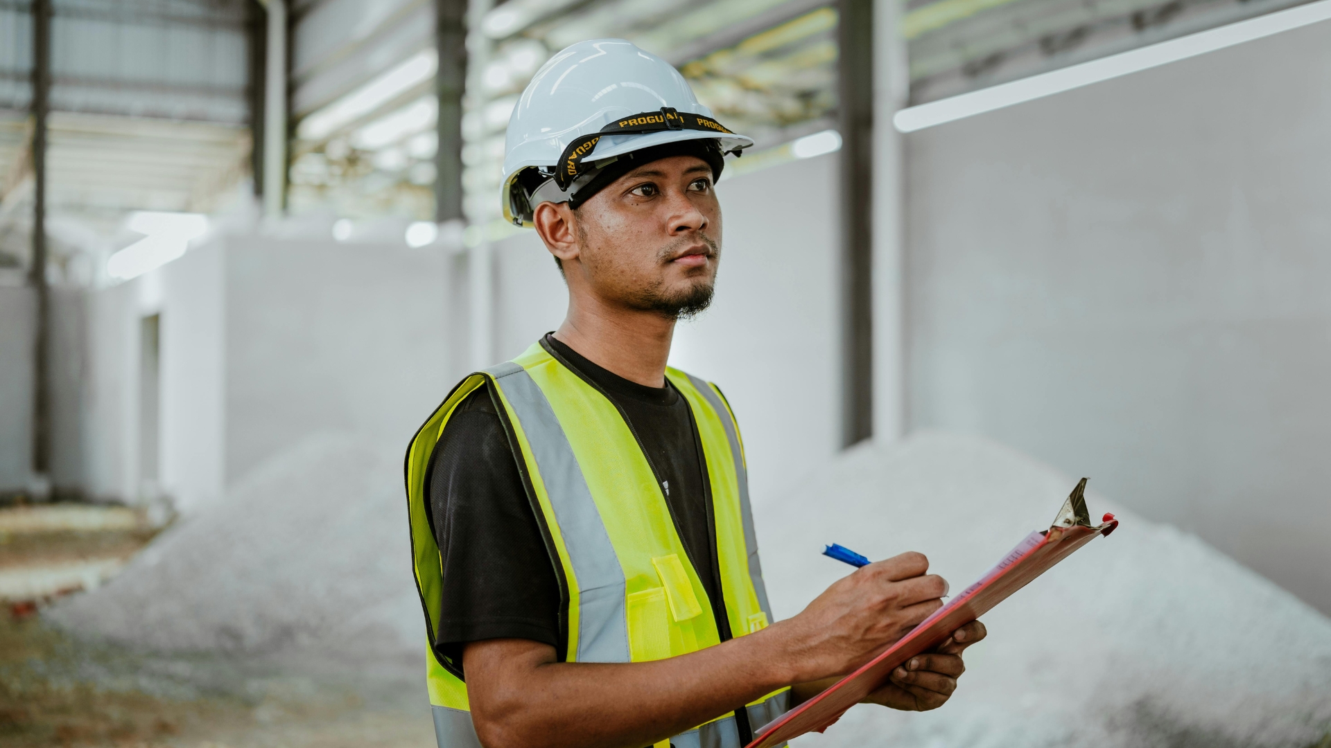 Construction worker reviewing pay records, an employee affected by new California labor laws
