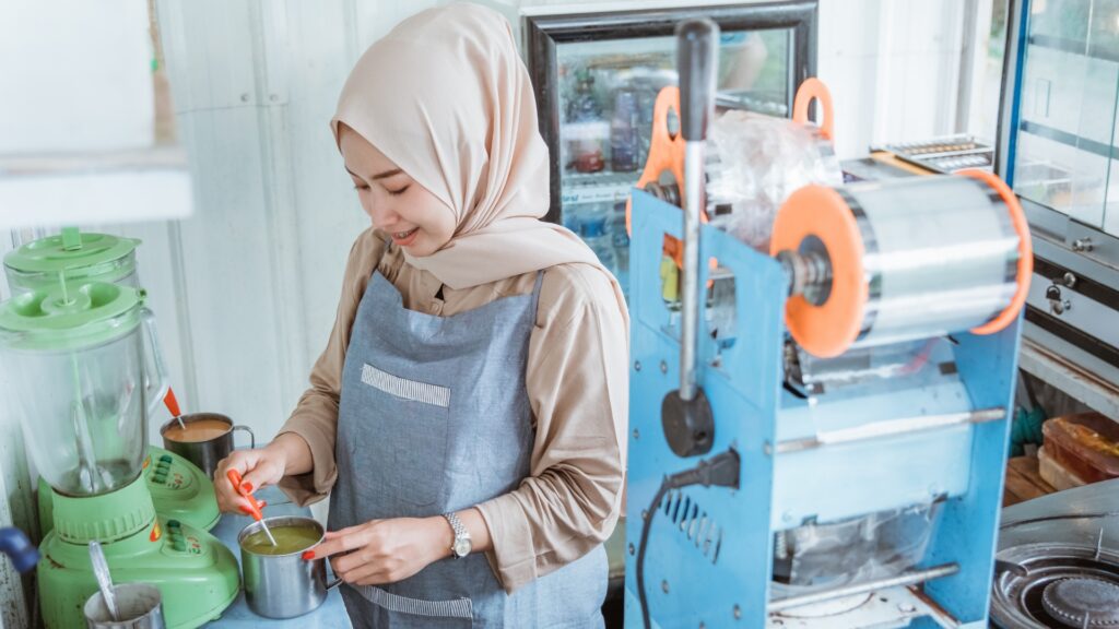 Employee wearing a hijab while working at a food service job, the kind of religious dress protected from religious discrimination in the workplace