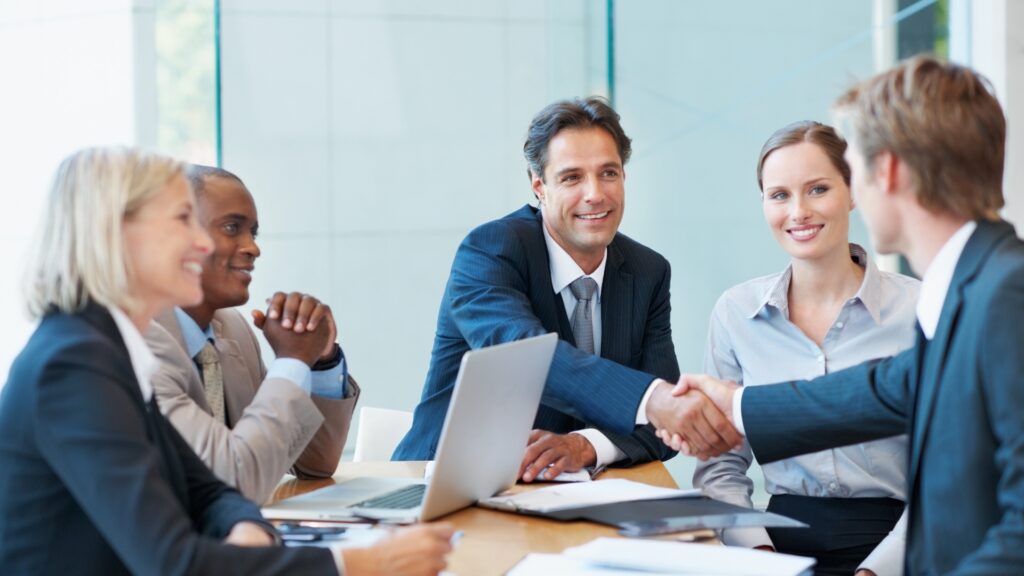 New employee shaking hands with a hiring manager during a job offer meeting in California