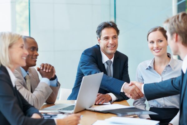 New employee shaking hands with a hiring manager during a job offer meeting in California