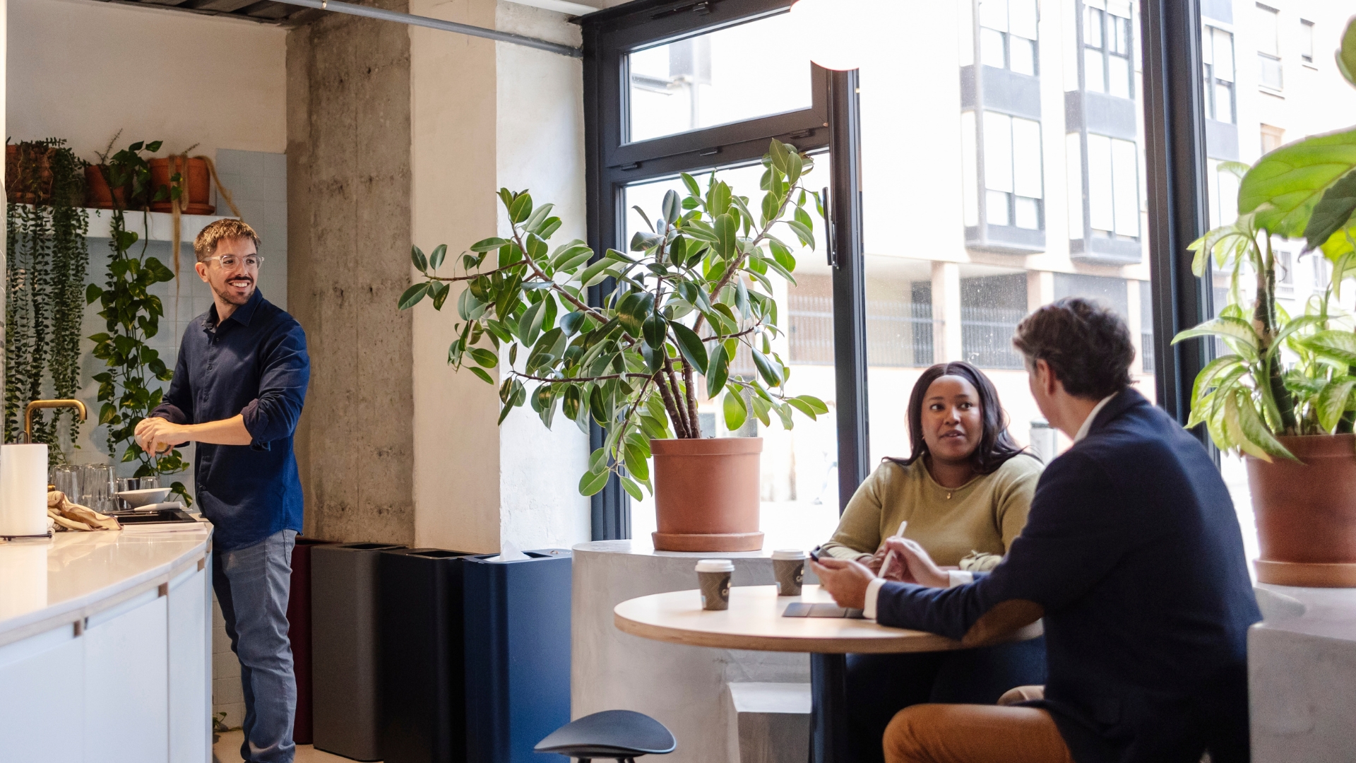 California employees gather in a break area to talk, reflecting the workplace conversations that happen around alternative workweek schedules and overtime rules