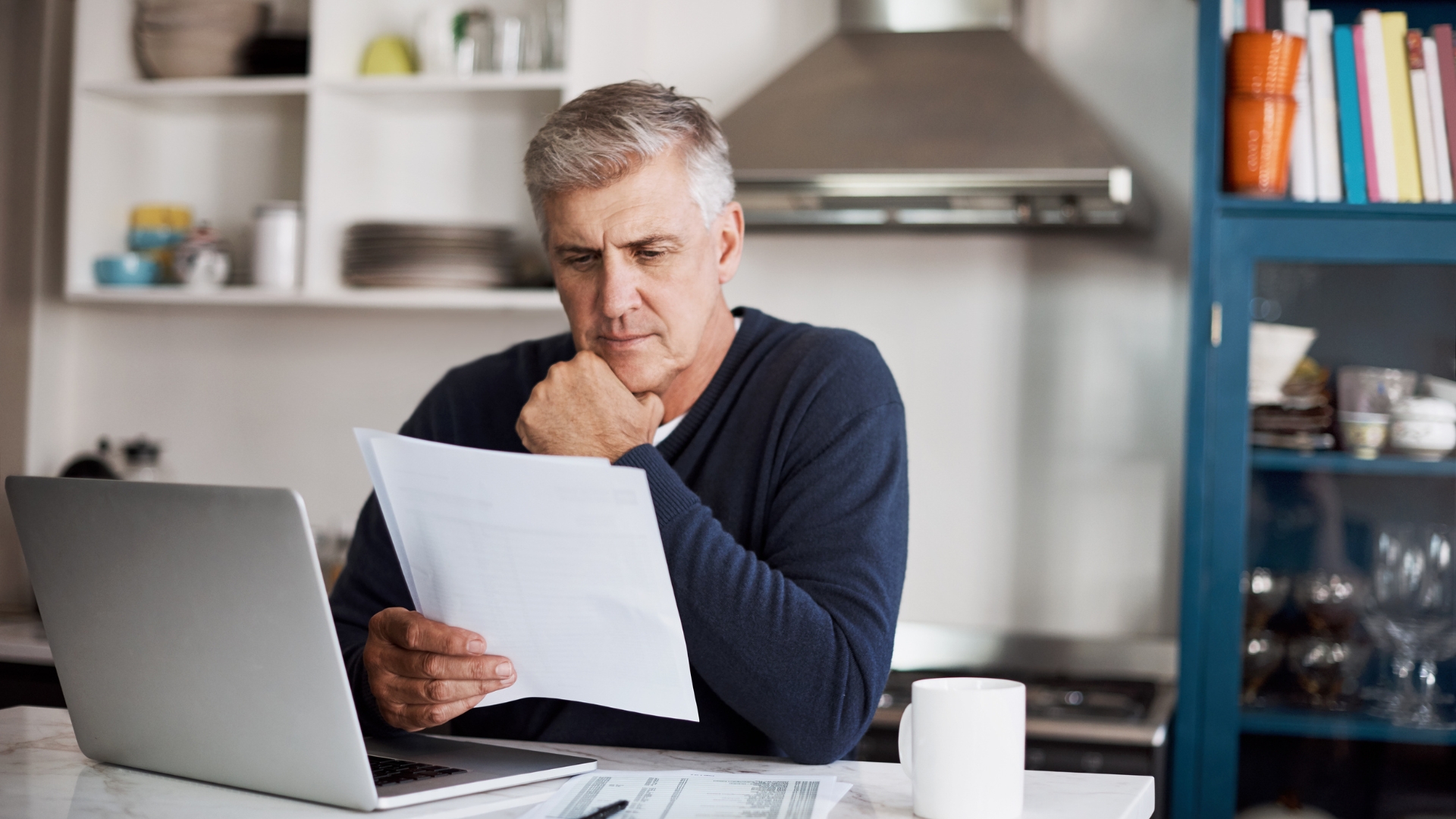 Employee reviewing pay stubs and records, the documents a Long Beach employment lawyer uses to build a termination claim