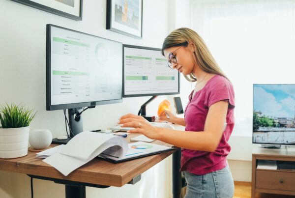 California employee standing at an adjustable desk, a reasonable accommodation for a physical disability