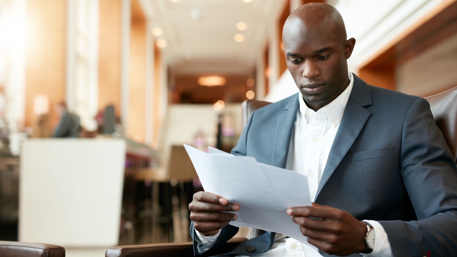 Employee carefully reading legal documents about race discrimination in the workplace
