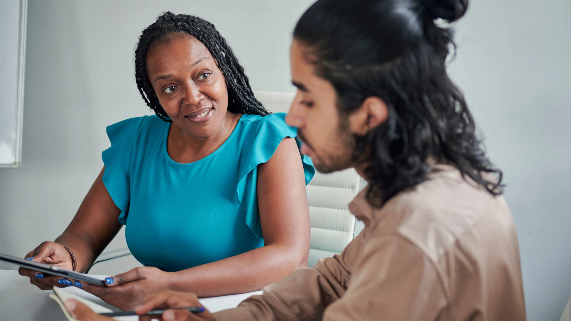 Employee and colleague talk through next steps for a workplace accommodation