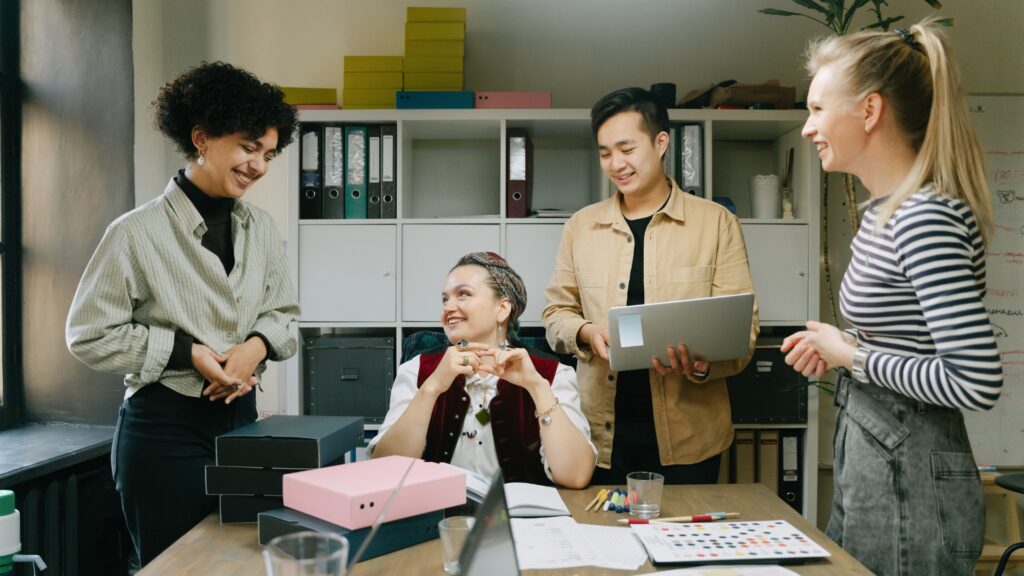 Diverse group of employees working together at a desk in a California office