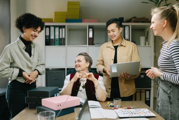 Diverse group of employees working together at a desk in a California office