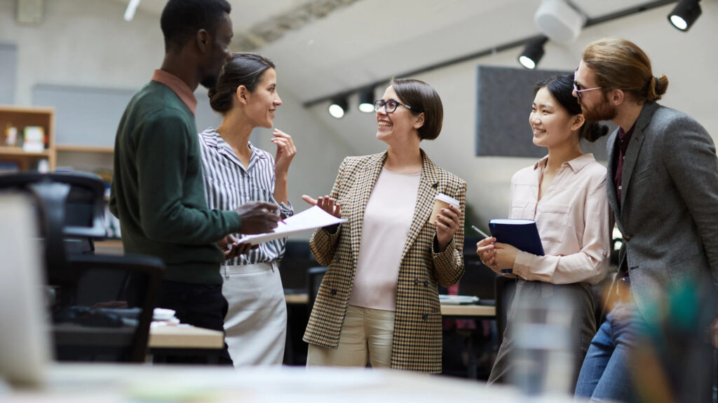A diverse group of California employees talking together during a workday