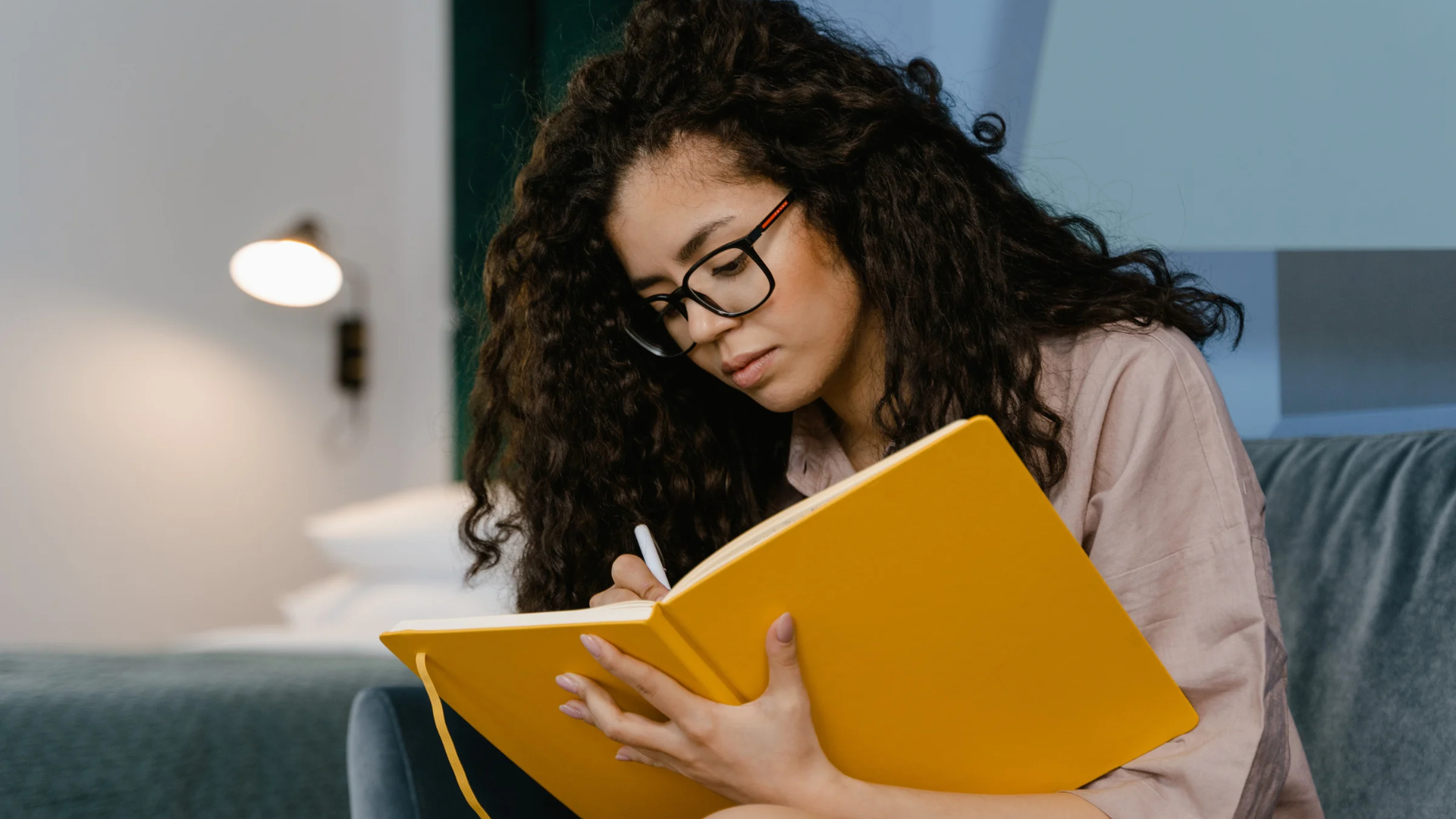 Woman writing in a private notebook to document details before she decides to report sexual harassment