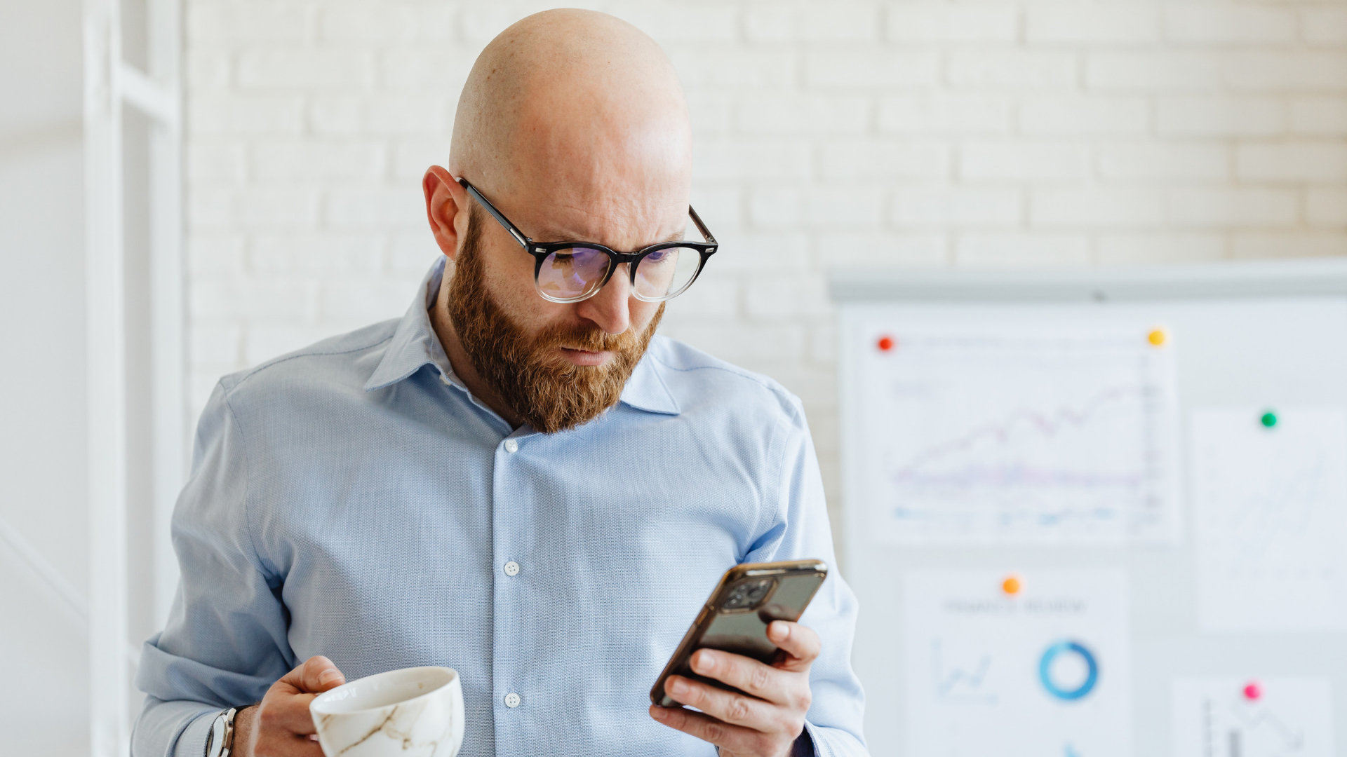 California employee checking his phone with a concerned look, wondering what is a PAGA claim