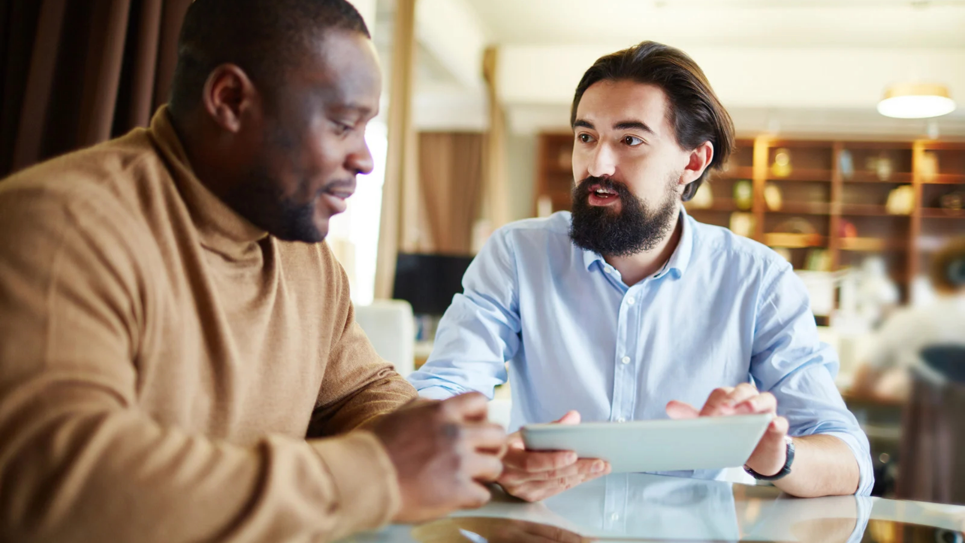 Employee in conversation with an attorney holding a tablet during a case consultation