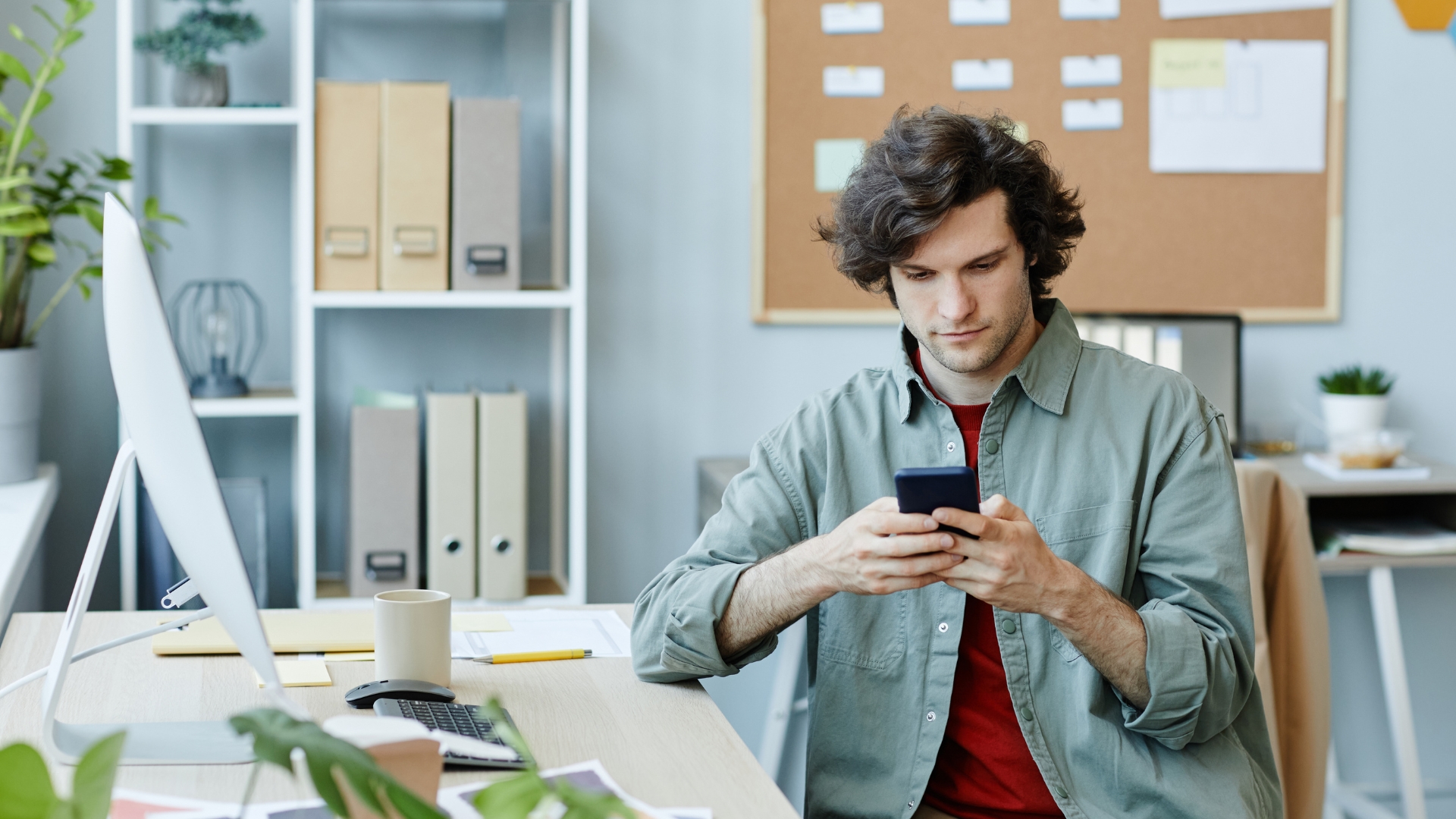 Employee reviewing text messages on his phone to document sexual harassment at work