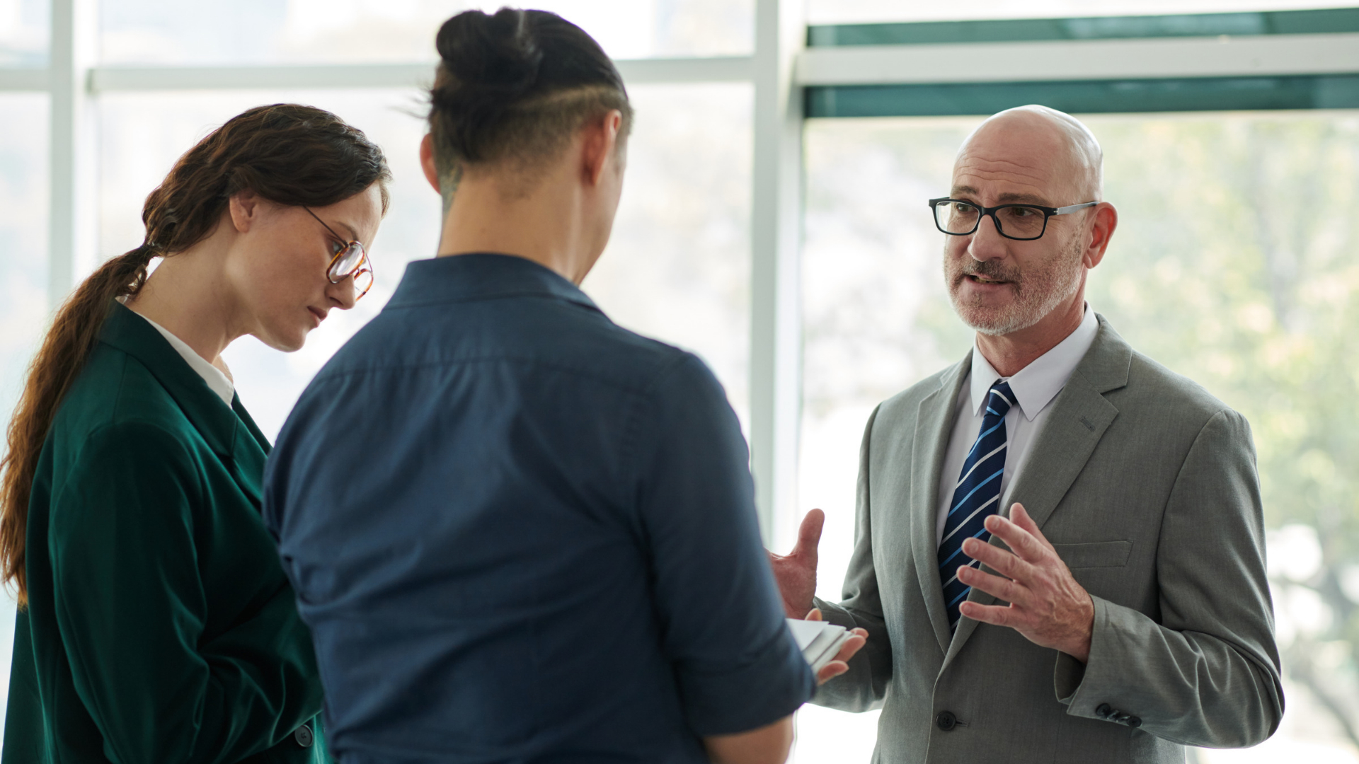 An employment attorney speaking with two employees during a wage claim consultation.